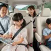 家族でシエンタに乗って長距離ドライブ中に、後部座席の子供たちがタブレットやスマートフォンで楽しそうにWi-Fiを利用している様子。